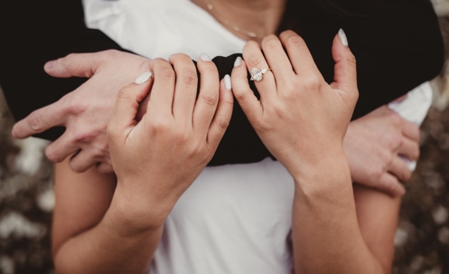 Bride and groom with engagement ring close up stock photo